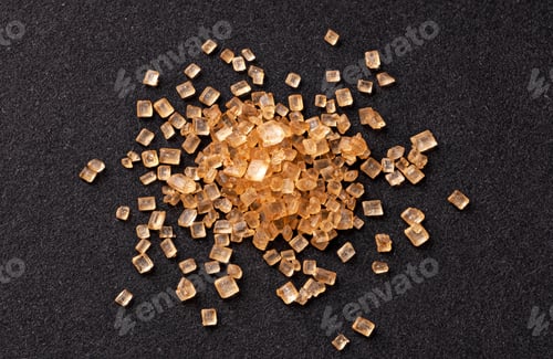 Preview: Pile of cane sugar on black background, top view