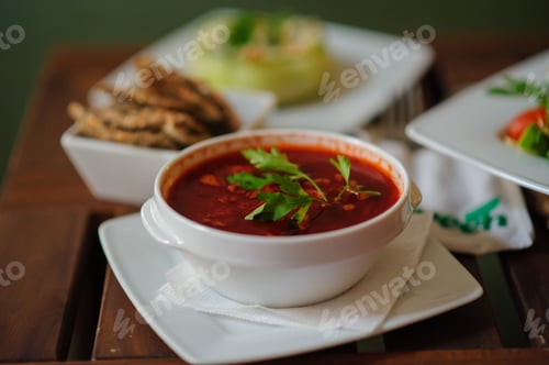 Preview: Vegan borscht in bowls on an old wooden background