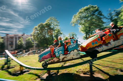 Preview: People Having Fun On Rollercoaster In Park. Photo With Zoom Blur