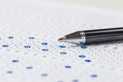 Preview: Students take multiple choice test with pen and answer sheet during exam session