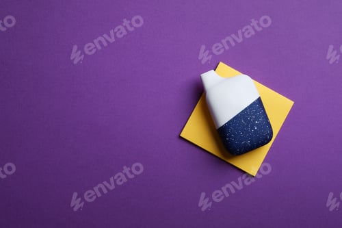 Preview: disposable electronic cigarette or vape on purple background. top view copy space. nicotine vapor