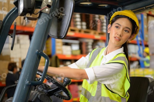 Preview: Female worker driving a forklift moving goods in the warehouse Practicing forklift operation