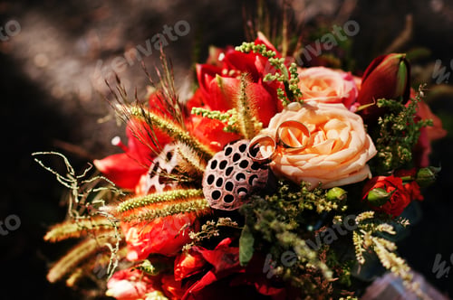 Preview: Close-up photo of isolated bridal bouquet laying on the ground.