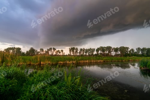 Preview: Thundercloud over the river. Summer landscape before the storm.