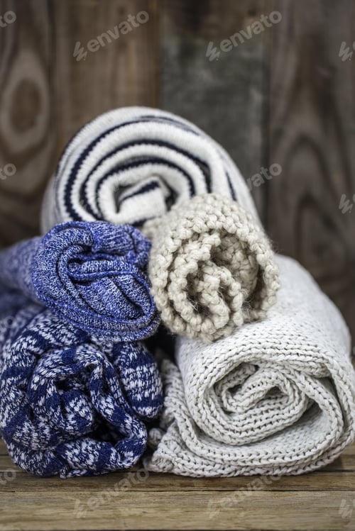 Preview: Sweaters on wooden background