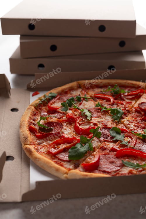 Preview: Large Pizza in open carton box on kitchen table closeup view