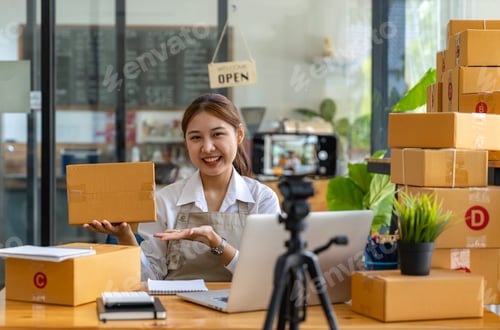 Preview: Startup small business SME. Beautiful asian entrepreneur using camera live streaming online chat wit