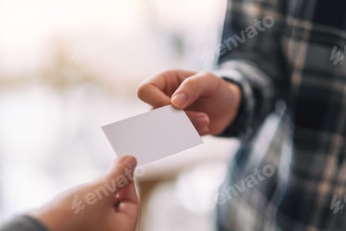 Preview: Two businessman holding and exchanging empty business card