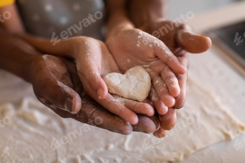Preview: African American Father And Daughter Holding Heart Made Of Dough In Hands