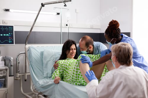 Preview: Young woman giving birth to child in hospital ward