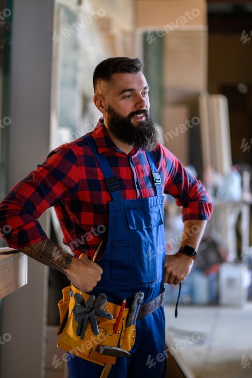 Preview: Young male carpenter working in workshop