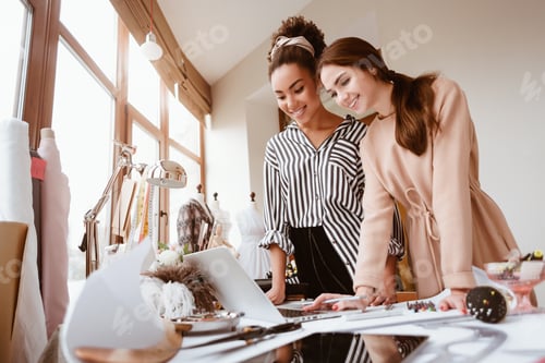 Preview: Two young attractive women talking at design studio