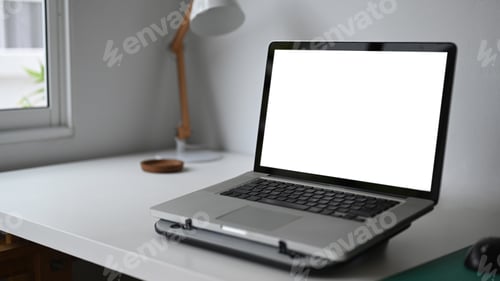 Preview: Simple workspace with laptop on white wooden table.Blank screen for graphics display montage.