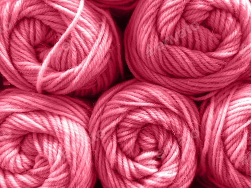 Preview: Wool yarn skeins are folded in stacks, close-up texture. Toned by color Viva magenta