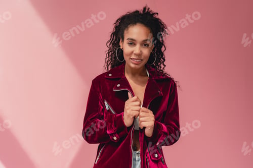 Preview: attractive black african american woman in stylish outfit on pink background