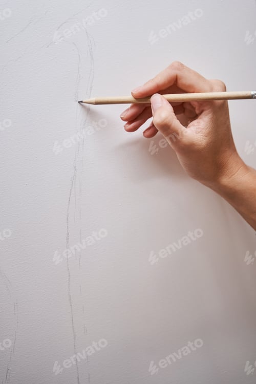 Preview: Focused photo on woman drawing line with pencil