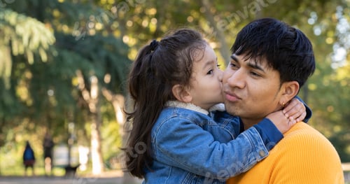 Preview: Headshot of hispanic father showing love , kissing and hugging outdoors with copy space