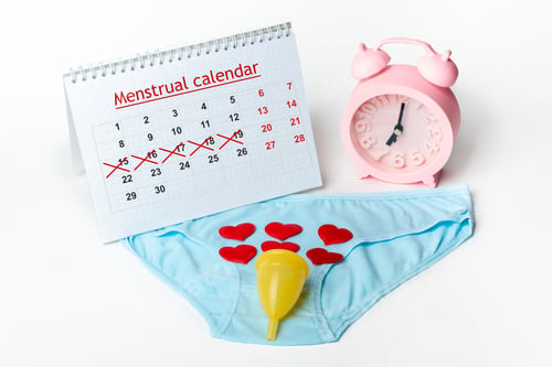 Preview: Women's underwear, menstrual cup with red hearts alarm clock and calendar with crossed-out dates