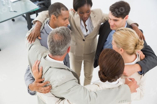 Preview: Diverse Business Team Hugging In A Circle In The Office