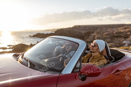 Preview: Lovely couple driving a cabriolet near the ocean