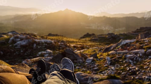 Preview: Panoramic detail of two pair of feet in front of a defocused landscape at sunset