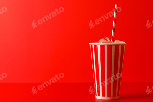 Preview: Paper cup with cola and ice over red background