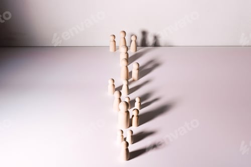 Preview: Small group of separated people seen from above represented anonymous with wooden figures