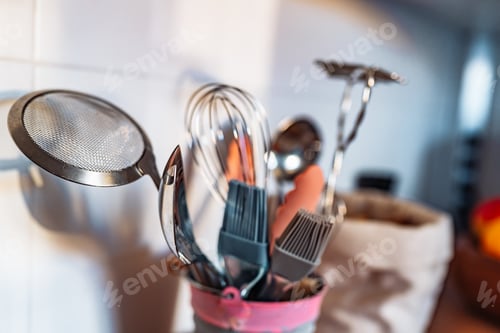 Preview: Kitchen utensils or cooking tools in iron decorative bucket, on kitchen wooden surface. Kitchen