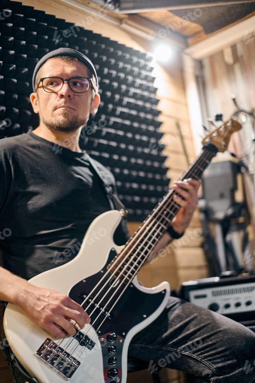 Preview: Bassist rehearsing in cozy studio