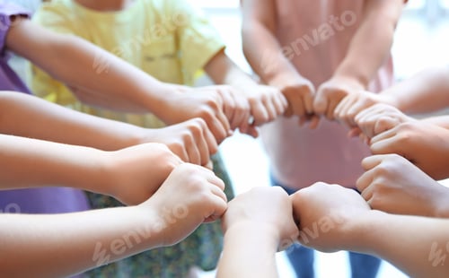 Preview: Little children putting their hands together, closeup. Unity concept