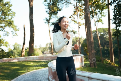 Preview: Young woman jogging outdoors representing health and wellness