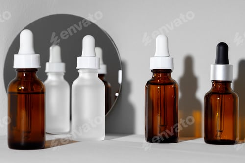 Preview: Creative photo with glass jar ofcosmetic oil and mirror
