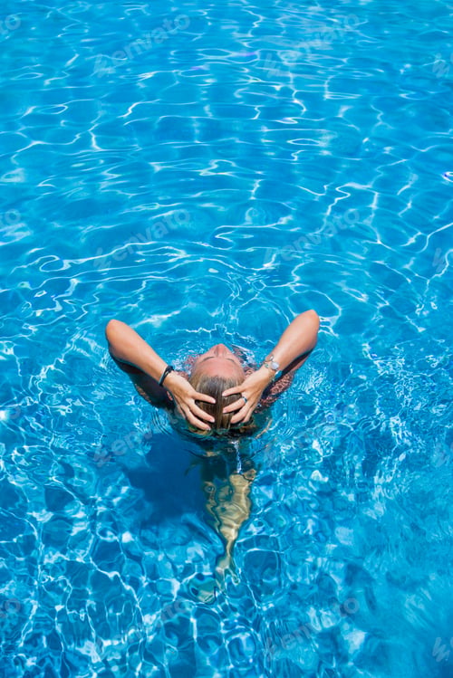 Preview: Woman standing in the pool