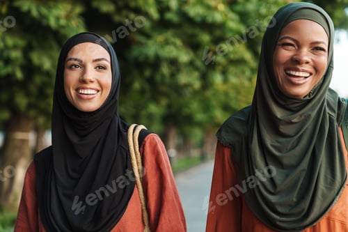 Preview: Smiling Women Outdoors in Hijabs and Casual Wear