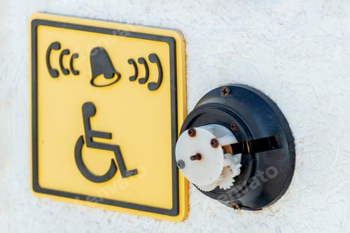 Preview: A broken call button for disabled people and a sign icon in front of the stairs to the beach