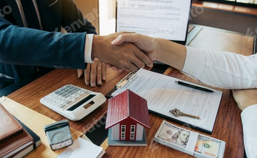 Preview: Home sales agents and buyers work on signing new homes and shaking hands.