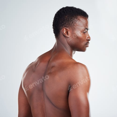 Preview: One African American fitness model posing against a white background. Confident young black man sho