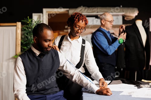 Preview: Suitmaker taking customer measurements