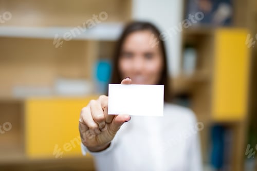 Preview: Young businesswoman holding a blank card for your message