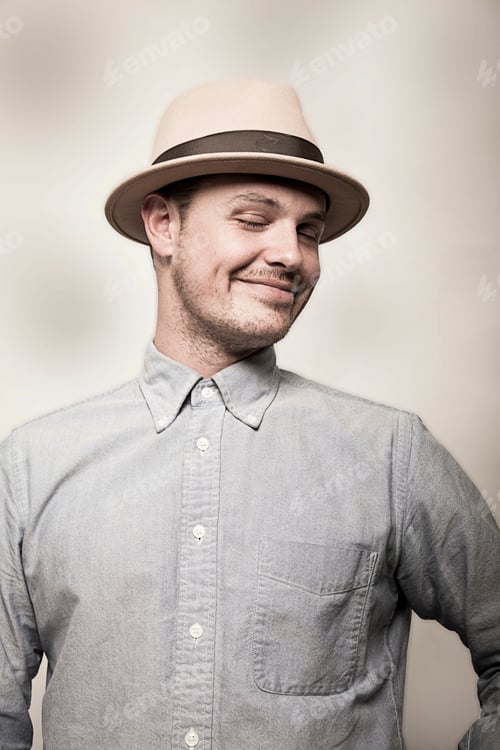 Preview: Portrait of man wearing hat and grey shirt