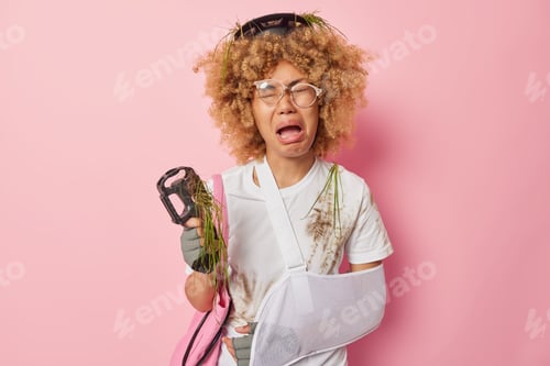 Preview: Unhappy woman got injured after falling off bike wears sling cries from despair and painful feelings