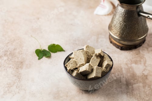 Preview: Halva slices in a bowl. Oriental sweetness. Copy space.