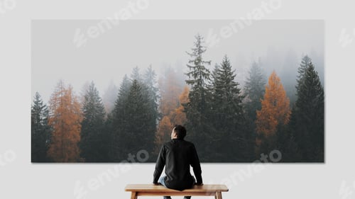 Preview: Man looking at forest image on the wall rear view