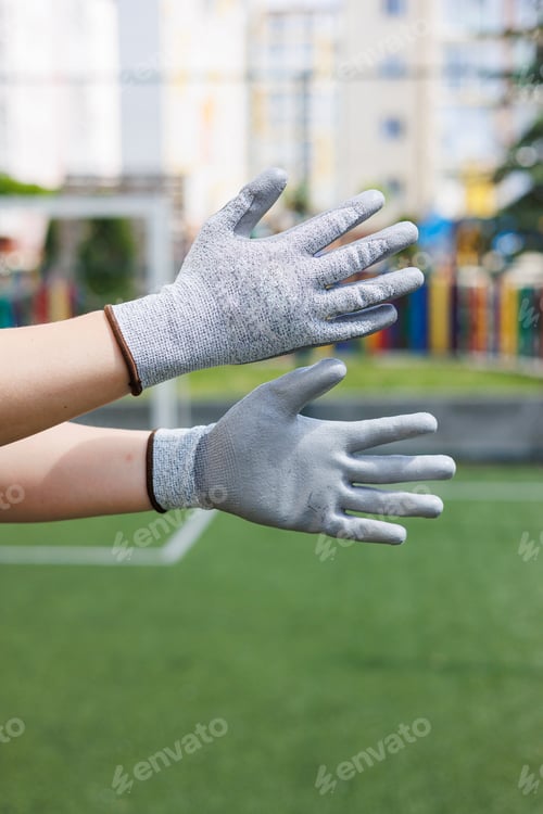 Preview: Close-up of male hands in construction gloves. Gloves for performing heavy dirty work