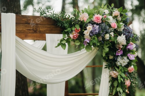 Preview: Wedding ceremony on the street on the green lawn.Decor with fresh flowers arches for the ceremony