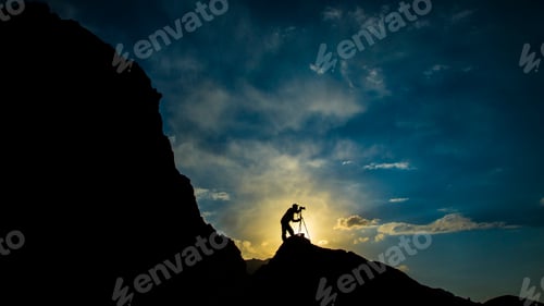 Preview: Silhouette of Photographer on Mountain at Sunrise