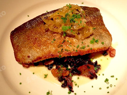 Preview: Delicious plated fish entree with rice and onions