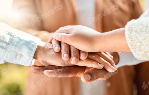 Preview: Shot of an unrecognizable family of three with their hands in a pile outside