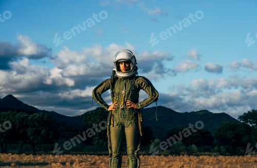 Preview: Beautiful woman poses looking at camera dressed as an astronaut.