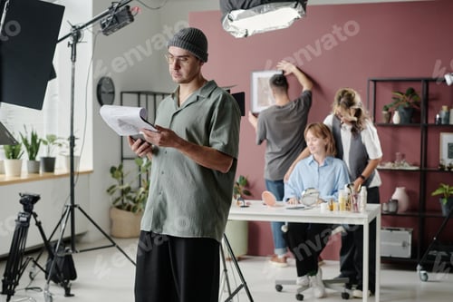 Preview: Man Reading Script during Shooting Day at Studio
